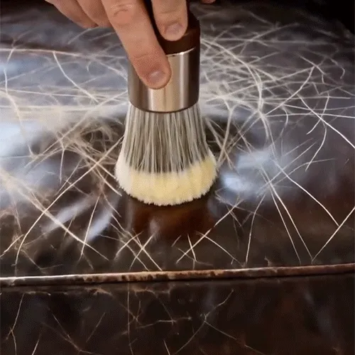 Animated leather care cream application with a brush